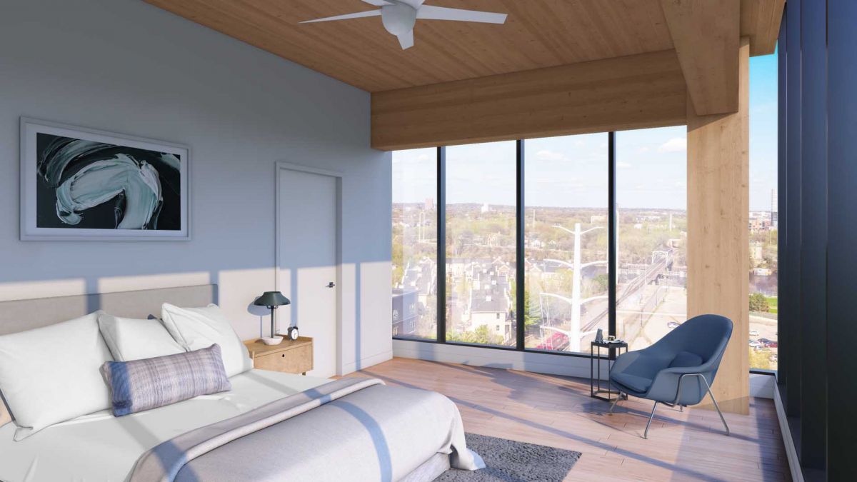 Empty room with light wood floor, white walls, ceiling fan, and sliding glass door opening to a patio with trees outside.