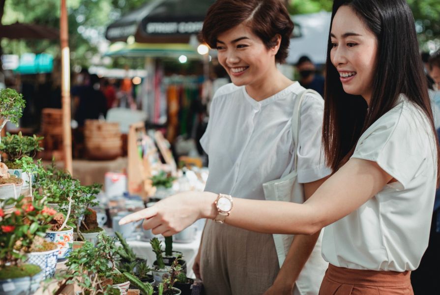 Young Women Shopping for Plants at Market