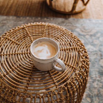 Latte in a mug on a wicker ottoman
