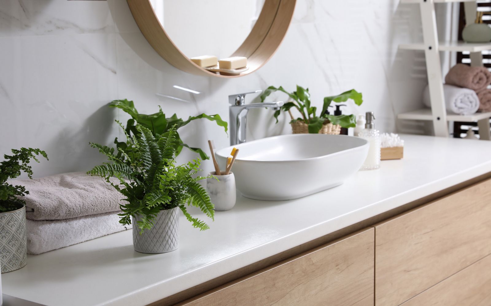 Modern bathroom with white countertops and raised sink