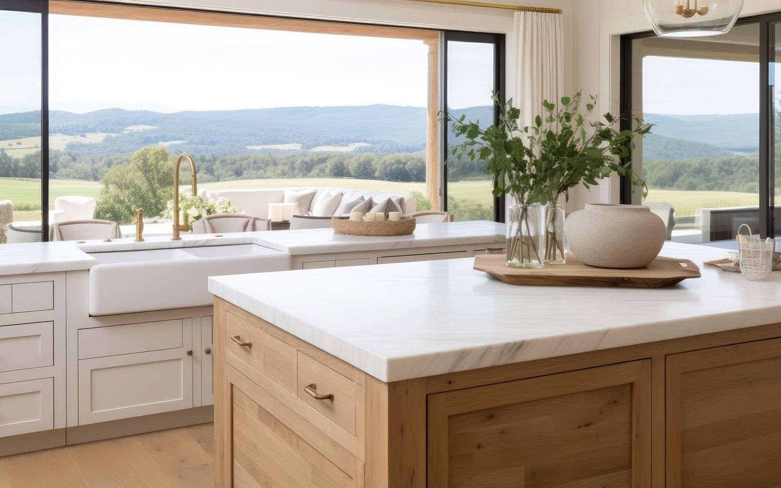 Modern kitchen with white marble countertops and wood cabinets with large mountain view