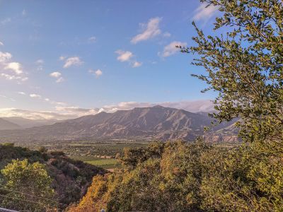Beautiful vista of purple-hued mountains in California countryside on sunny day