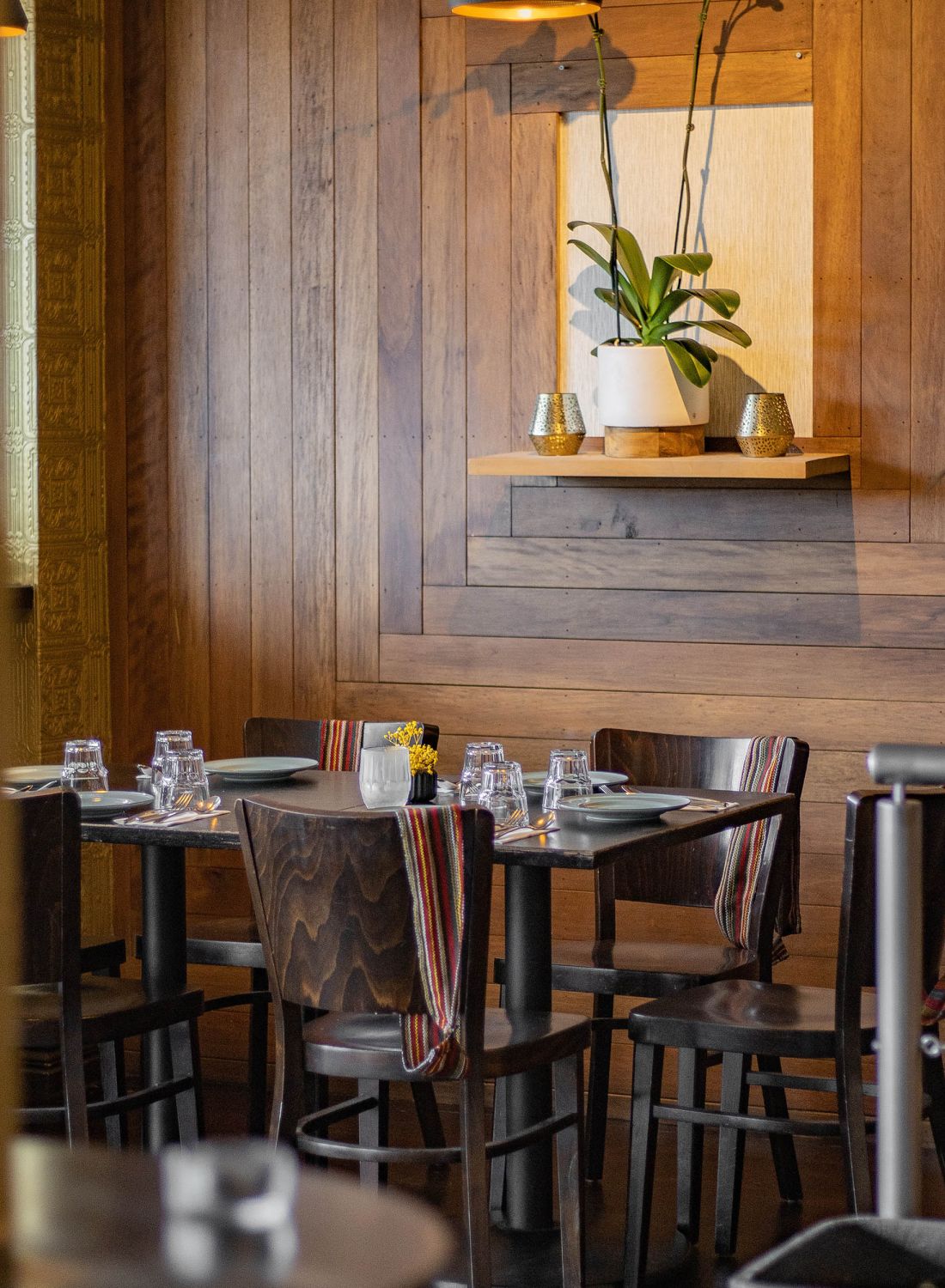 Restaurant with wooden panel walls and dark brown furniture