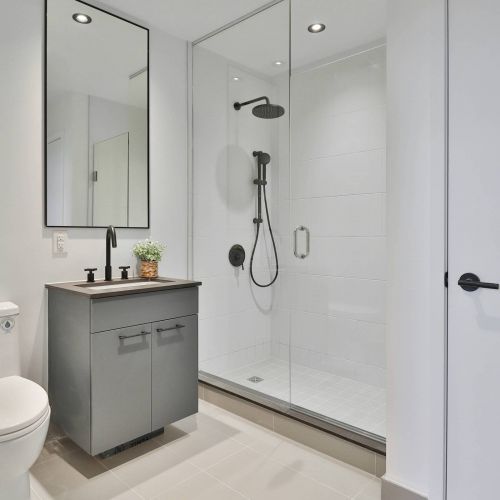 Xcelsior apartment theme white bathroom with single shower and white tile