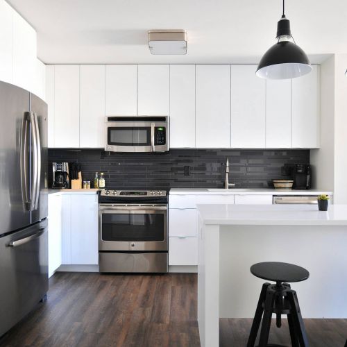 Xcelsior apartment theme 1 bedroom kitchen with white cabinets and stainless steel appliances