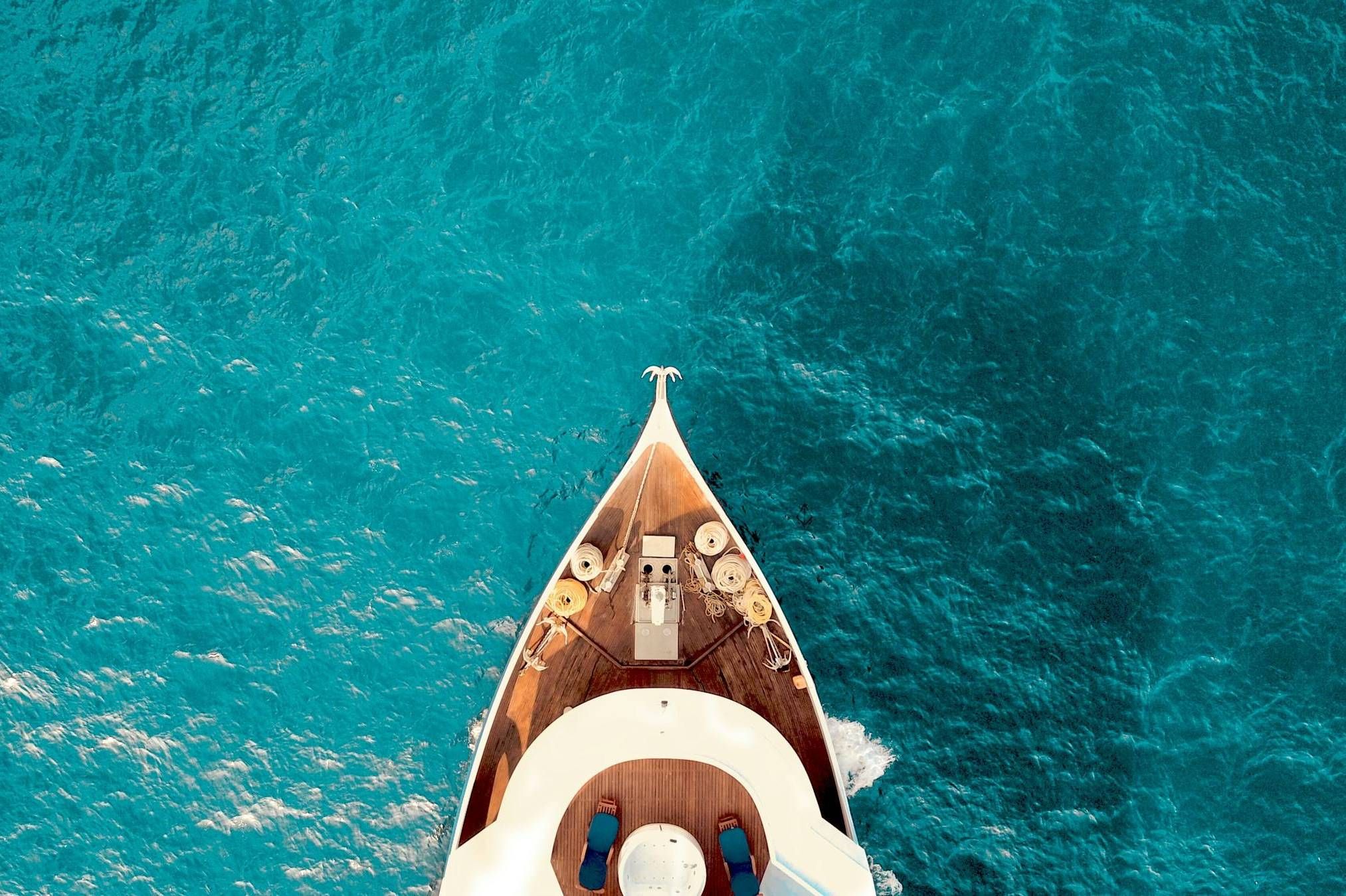 Yucatan by Resi - Luxury Apartment Website Theme - front of a boat floating on aqua ocean water